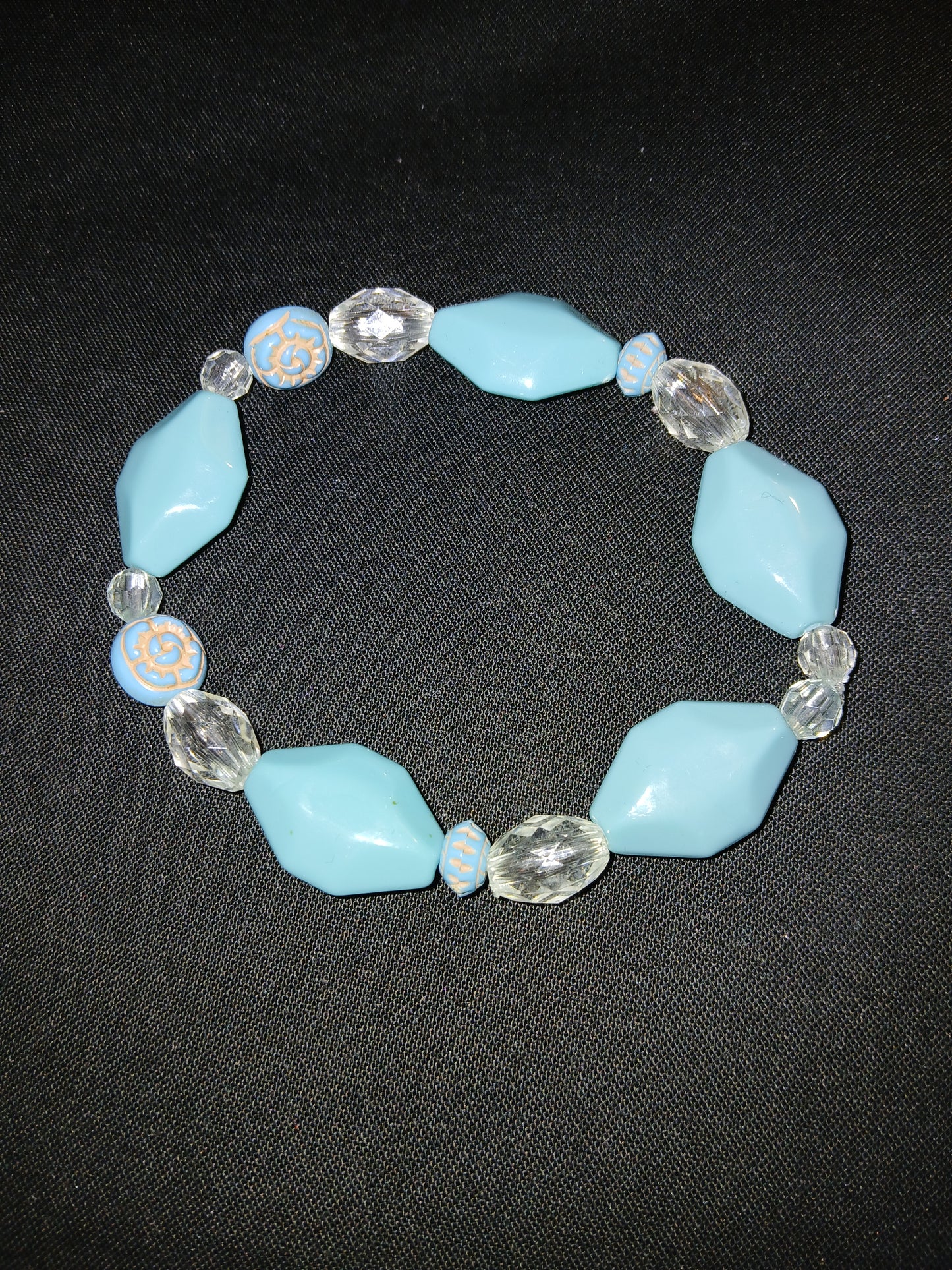 Handmade geometric shaped blue , clear, and beige bracelet.