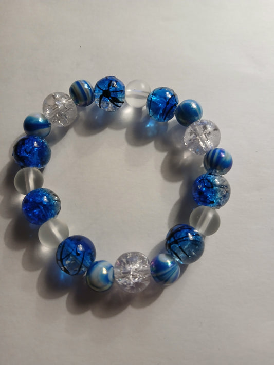 Homemade multi colored blue, black, clear, and white bracelet.