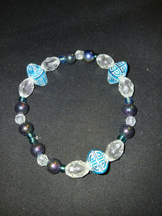 Handmade geometric shaped blue and gold beads, clear, blue, and metallic multi colored beads bracelet.