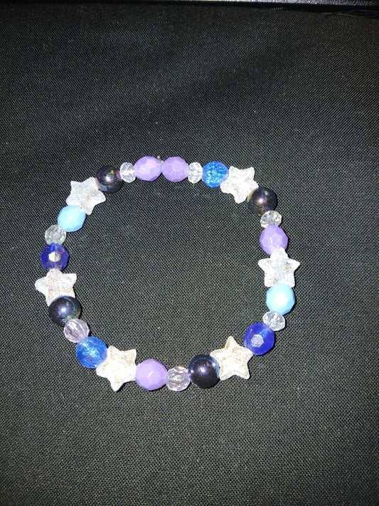 Handmade multi color purple, blue, clear, white, and glitter stars bracelet.