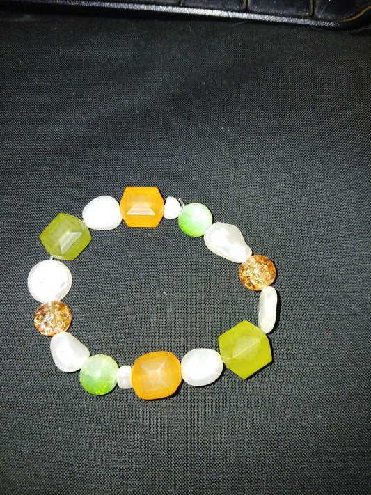 Handmade white, green, and orange bracelet.