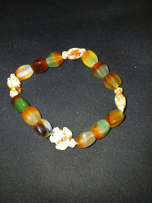 Handmade geometric shaped orange, brown and green  with multi colored sea turtles bracelet.