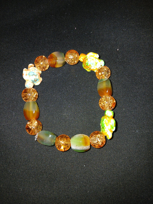 Handmade orange,  brown, green, white, and sea turtle bracelet.