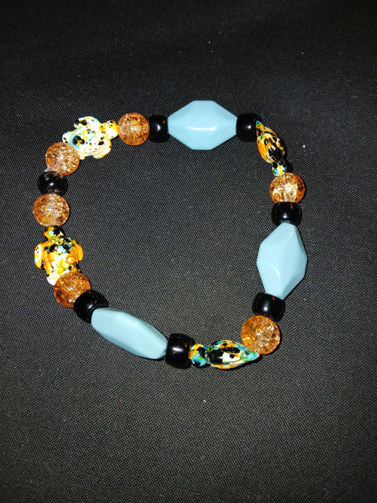 Handmade geometric shaped blue, black, white, orange, and multi colored sea turtle bracelet.