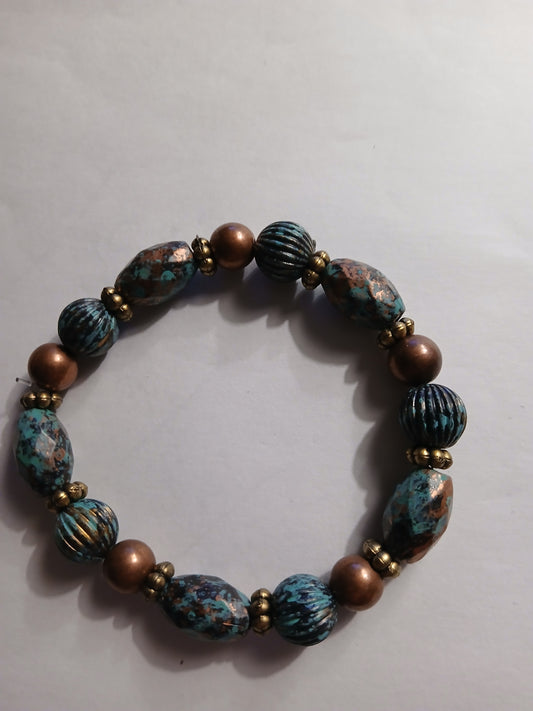 Homemade multi colored blue, black and bronze beads, with bronze spacer beads bracelet.