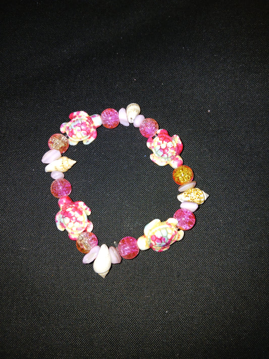 Handmade pink, clear, brown, blue, and white with sea turtles and sea shells bracelet