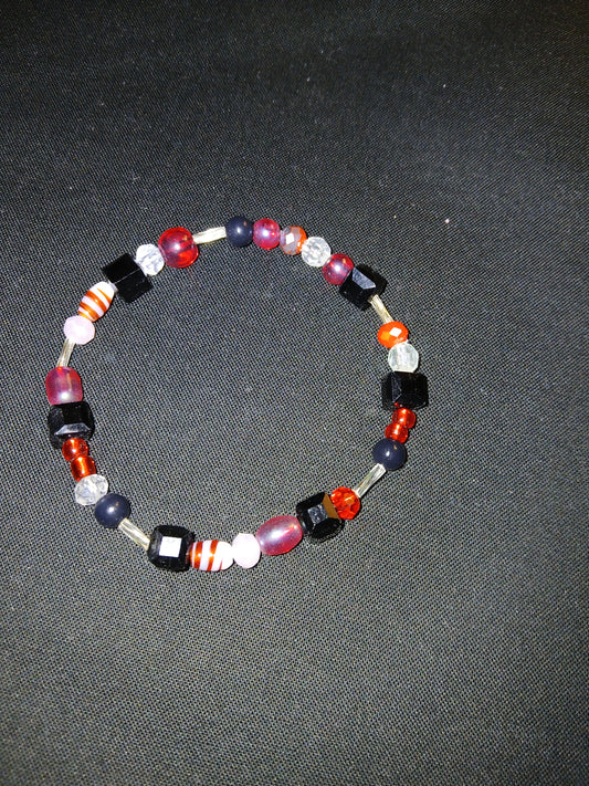 Handmade black, white, clear, silver, and red bracelet.