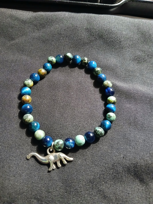Handmade multi colored blue , black, brown and aqua lava stone bracelet with silver dinosaur charm.